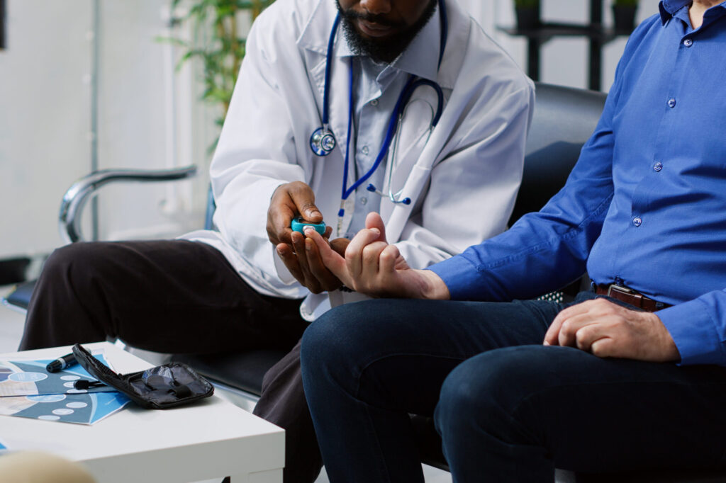doctor is sitting with patient doctor is checking blue color hand