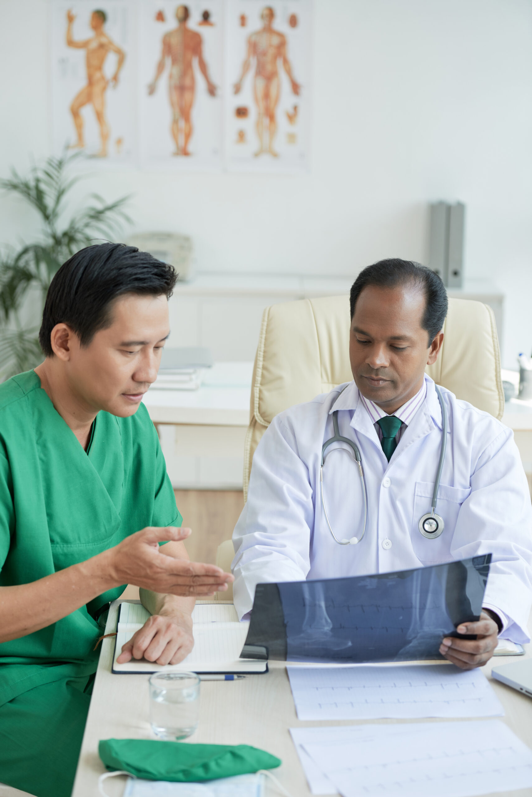 physician and surgeon sitting at table