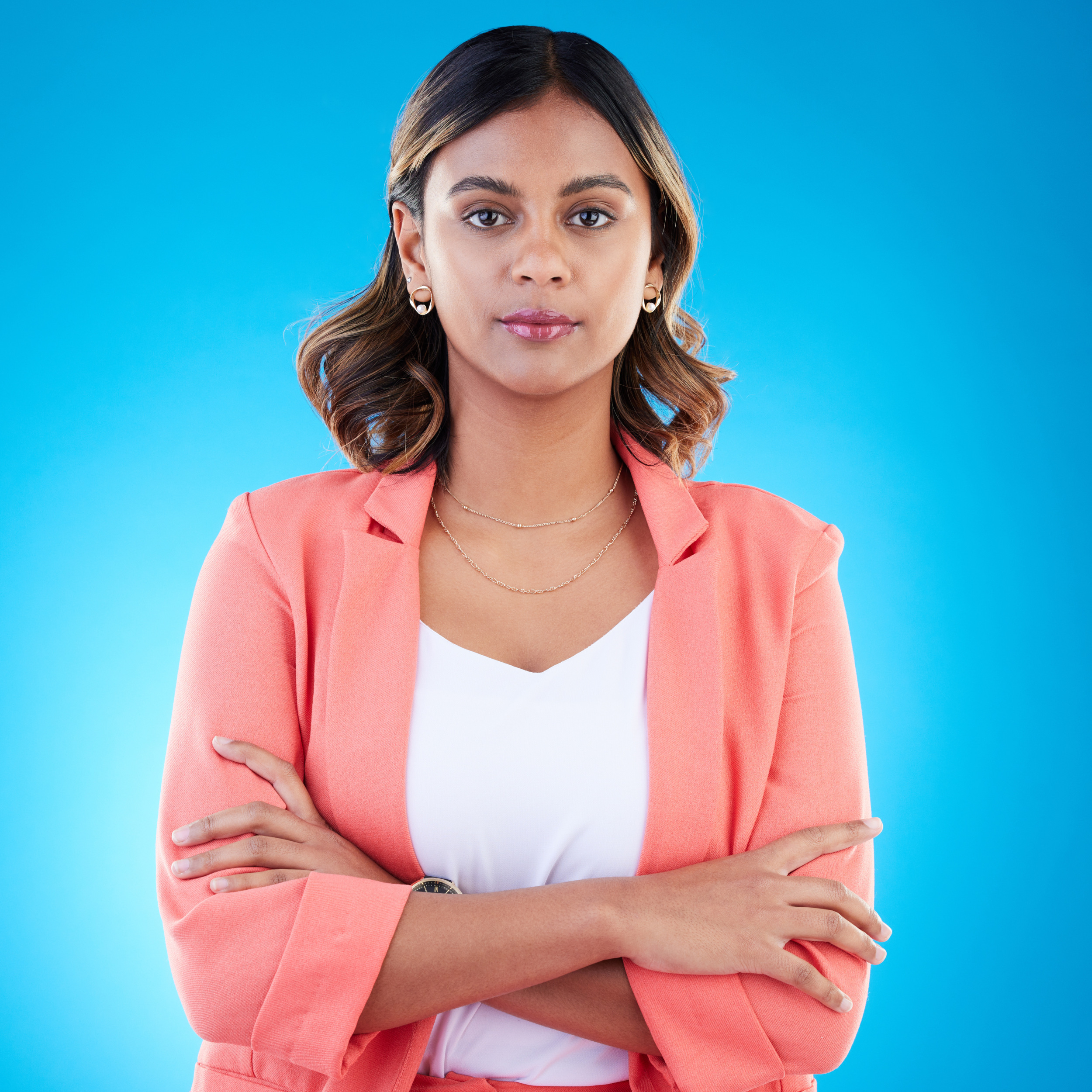 serious portrait business woman with arms crossed studio isolated blue background with pride career face professional confident assertive proud female entrepreneur from india